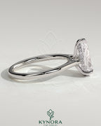 Kynora CJ 2ct pear-shaped diamond solitaire engagement ring with hidden halo, tapered band, and cathedral high setting.