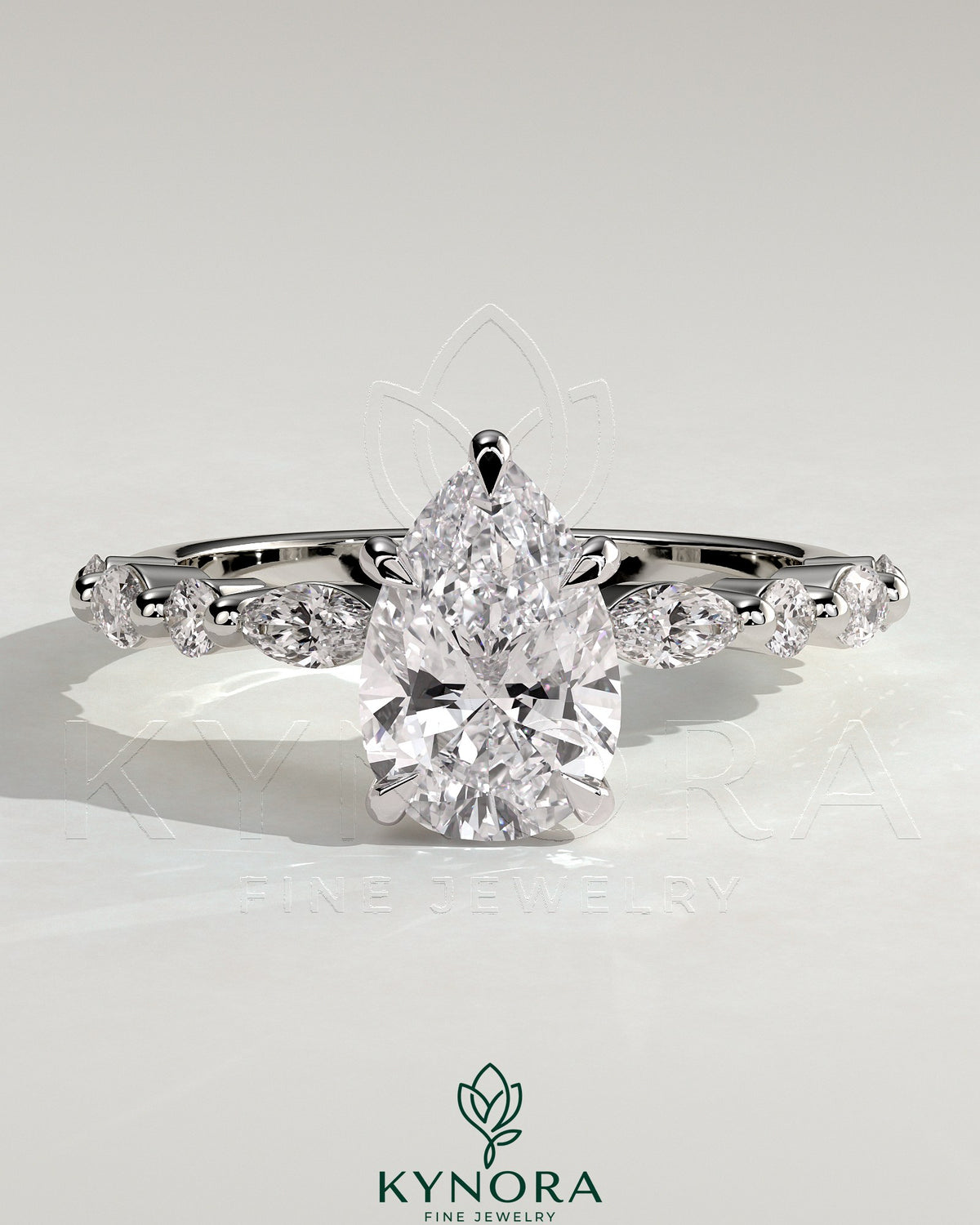 Kynora CJ 2ct pear-shaped diamond solitaire engagement ring with marquise and round accent stones on a silver band. Main image