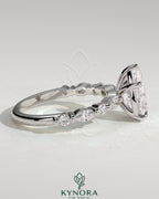Kynora CJ 2ct pear-shaped diamond solitaire engagement ring with marquise and round accent stones, elegant and sparkling jewelry.