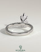 Kynora CJ 2ct pear-shaped diamond solitaire engagement ring with pave band, showcasing elegant jewelry design.