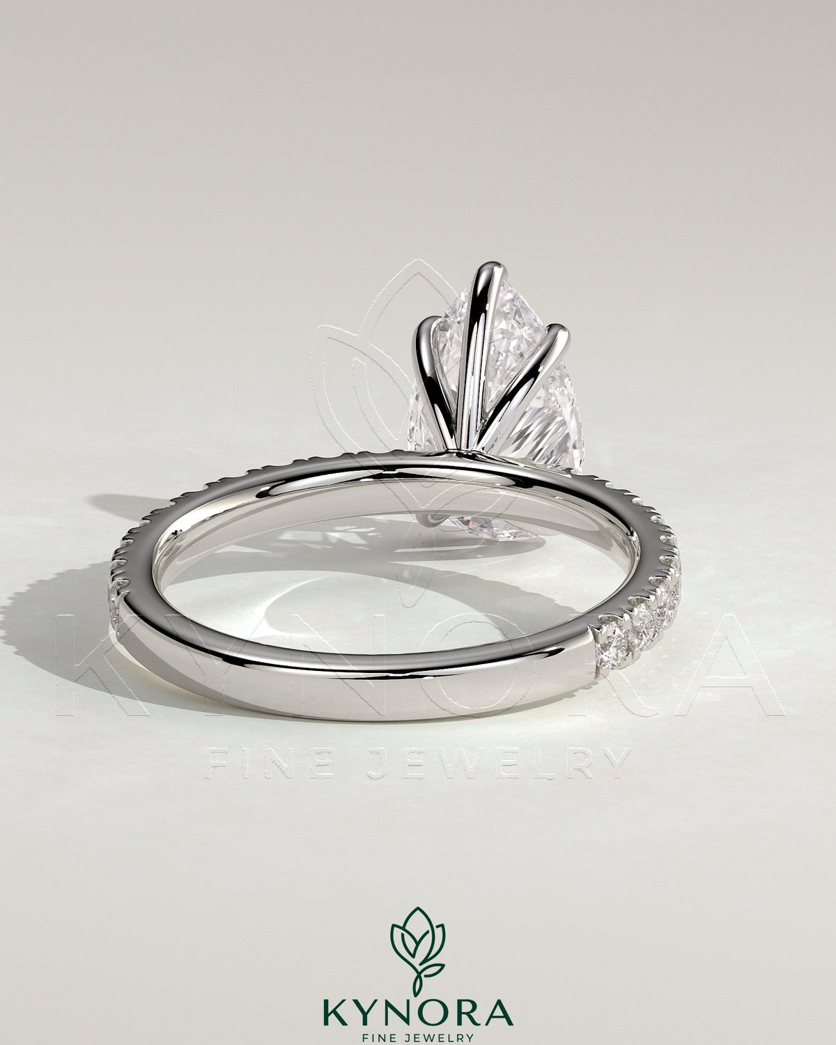 Kynora CJ 2ct pear-shaped diamond solitaire engagement ring with pave band, showcasing elegant jewelry design.