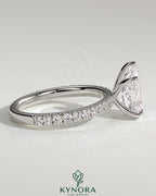 Kynora CJ 2ct pear-shaped diamond solitaire engagement ring with pave band, featuring a sleek gold setting and elegant design.