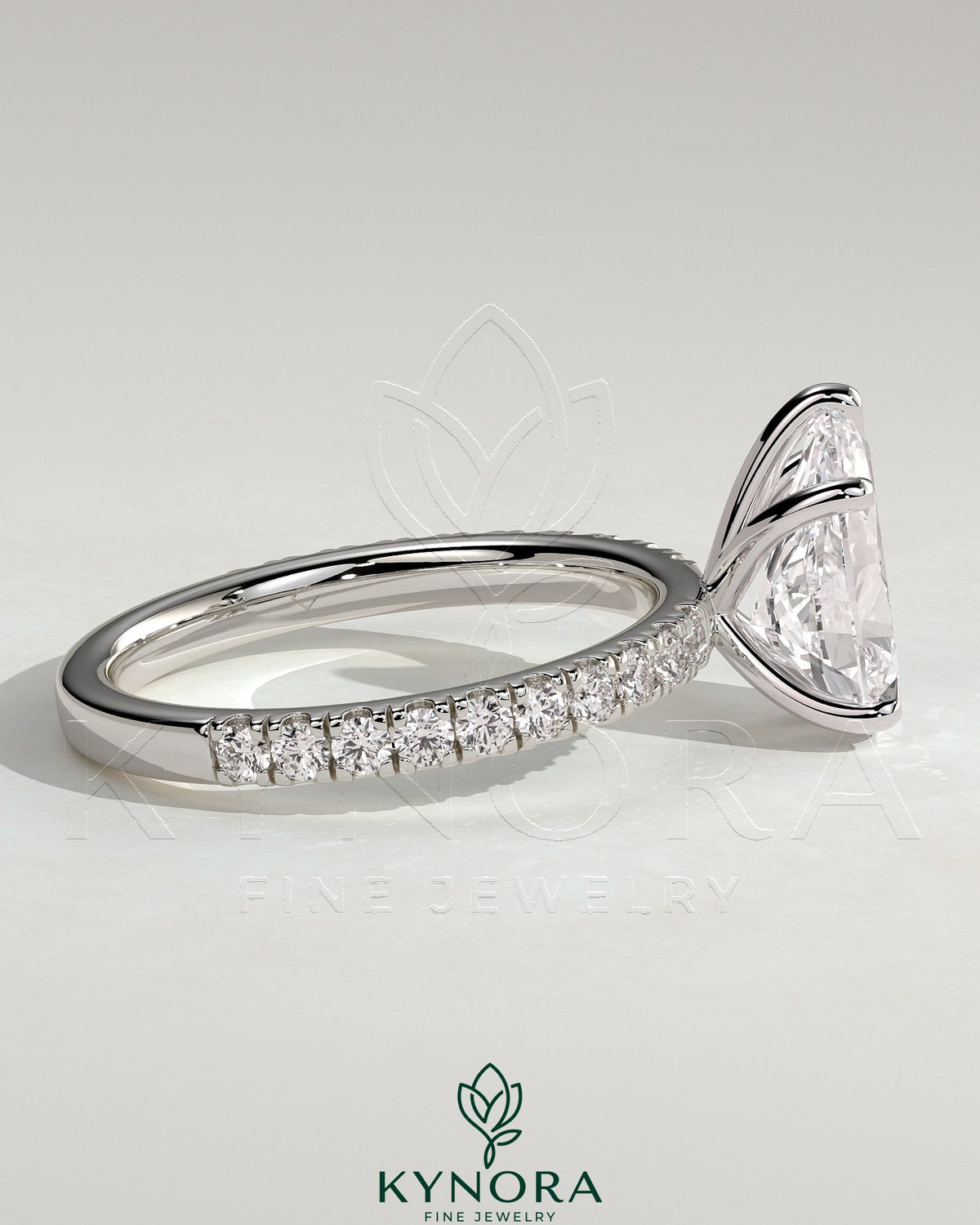 Kynora CJ 2ct pear-shaped diamond solitaire engagement ring with pave band, featuring a sleek gold setting and elegant design.