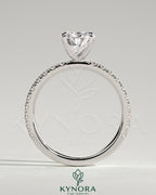 Kynora CJ 2ct pear-shaped diamond solitaire engagement ring with pave band, showcasing elegant jewelry design.