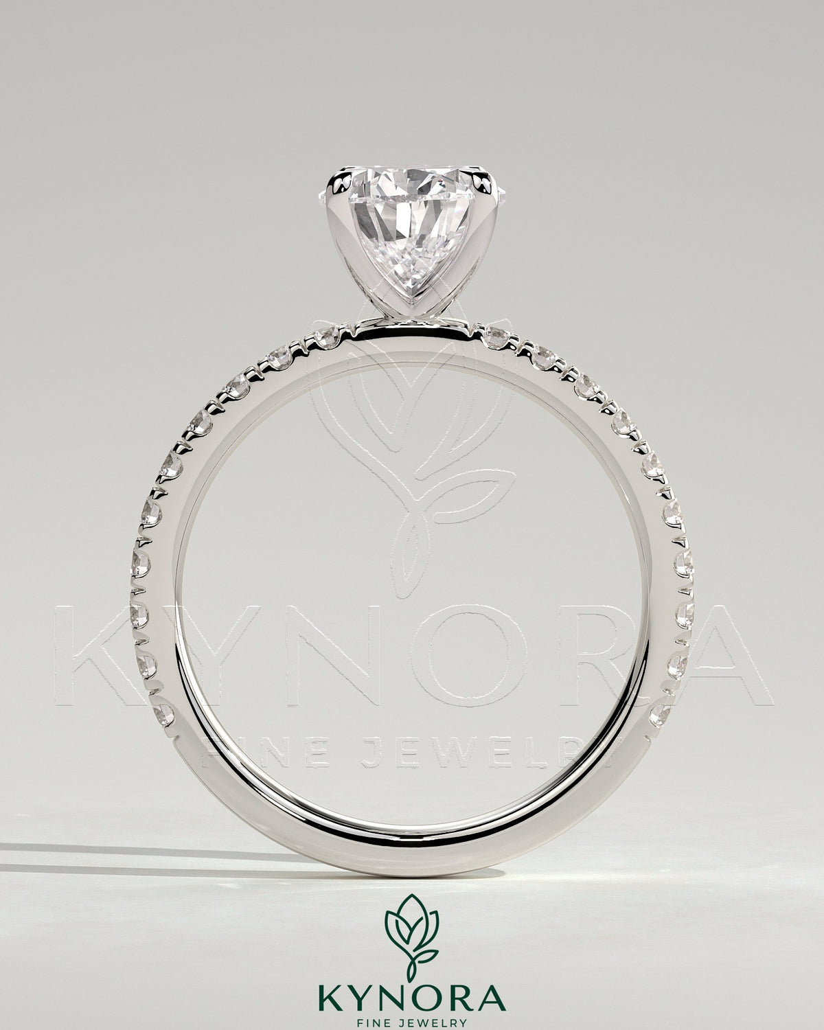 Kynora CJ 2ct pear-shaped diamond solitaire engagement ring with pave band, showcasing elegant jewelry design.