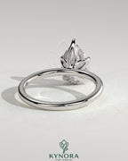 Kynora CJ 2ct pear-shaped diamond solitaire engagement ring with petal gallery and accented tiara detail, elegant jewelry design.