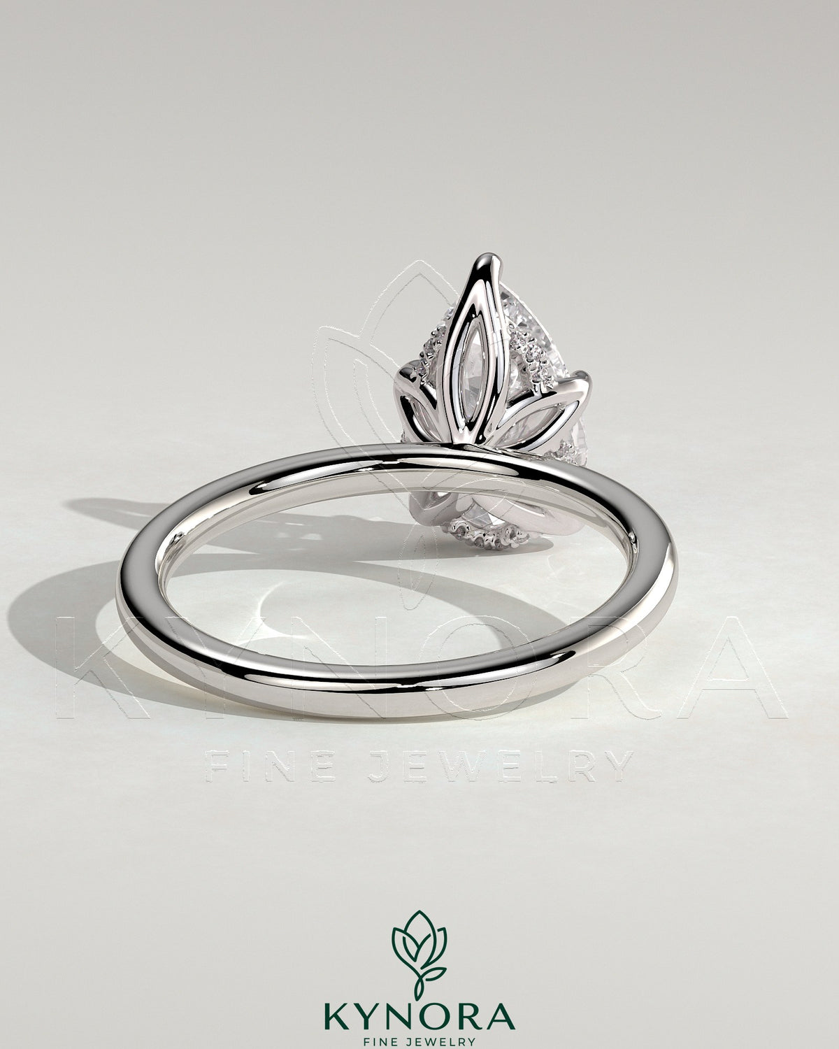 Kynora CJ 2ct pear-shaped diamond solitaire engagement ring with petal gallery and accented tiara detail, elegant jewelry design.