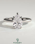 Kynora CJ 2ct pear-shaped diamond solitaire engagement ring with pinched tapered band and cathedral low setting.