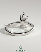 Kynora CJ 2ct pear-shaped diamond solitaire engagement ring with pinched tapered band and cathedral low setting.