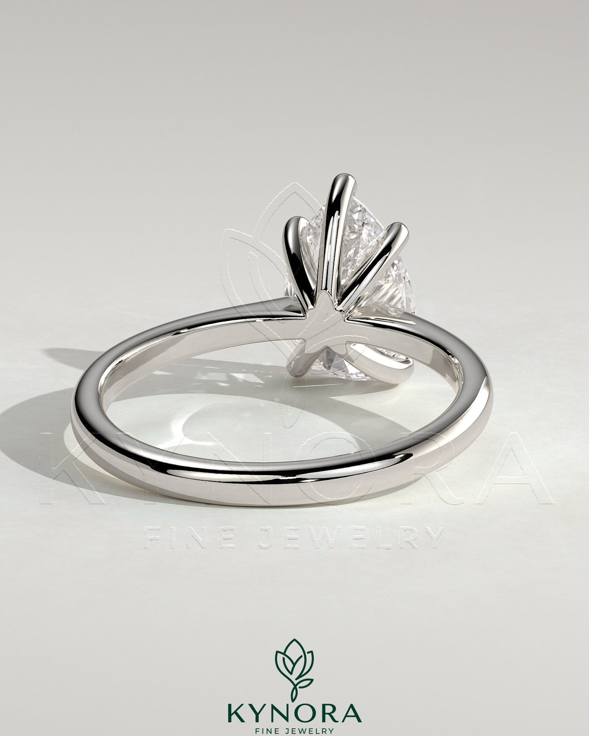 Kynora CJ 2ct pear-shaped diamond solitaire engagement ring with pinched tapered band and cathedral low setting.