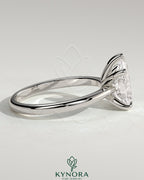 Kynora CJ 2ct pear-shaped diamond solitaire engagement ring with pinched tapered band and cathedral low setting.