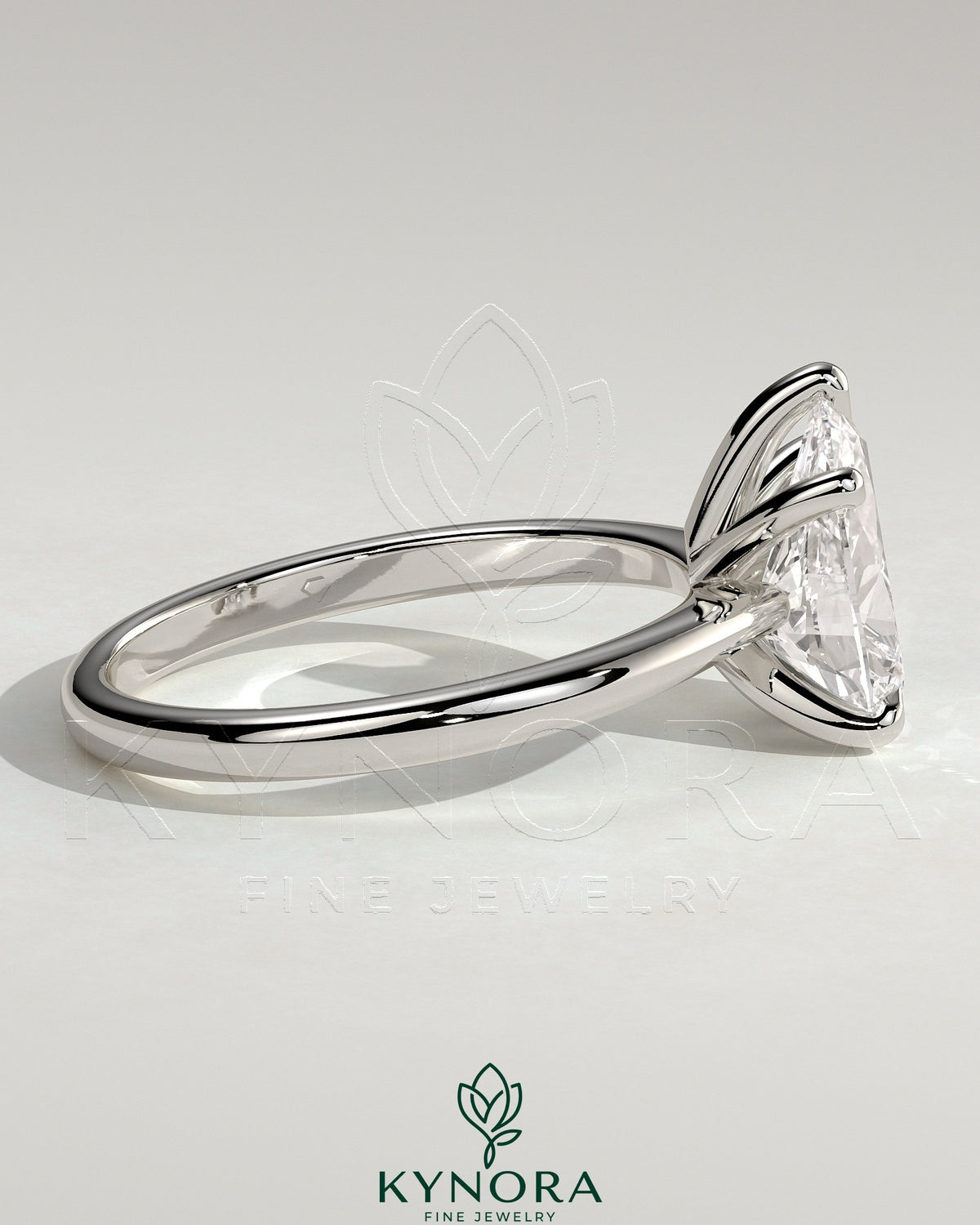 Kynora CJ 2ct pear-shaped diamond solitaire engagement ring with pinched tapered band and cathedral low setting.