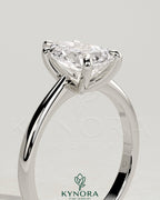Kynora CJ 2ct pear-shaped diamond solitaire engagement ring with pinched tapered band and cathedral low setting.