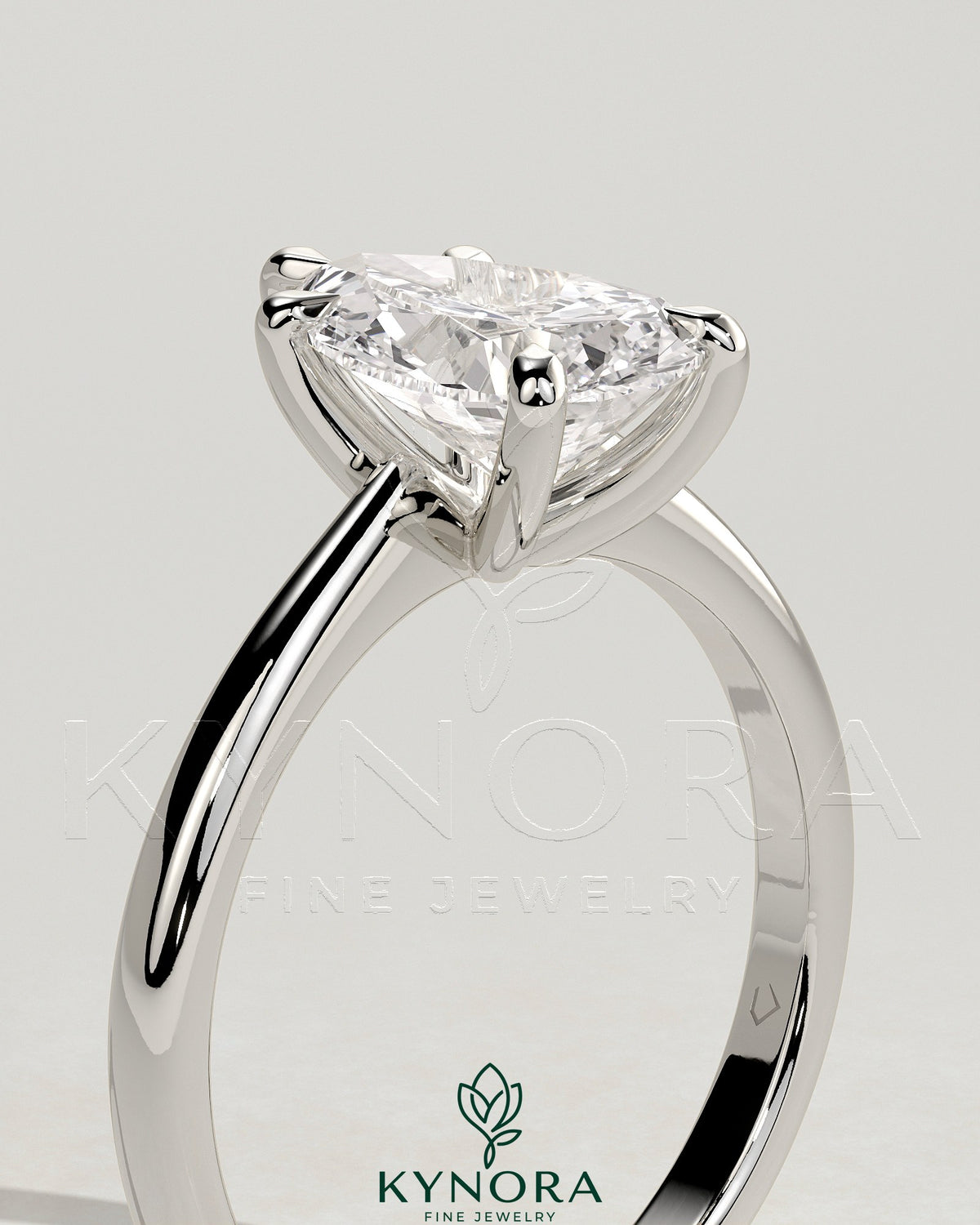 Kynora CJ 2ct pear-shaped diamond solitaire engagement ring with pinched tapered band and cathedral low setting.