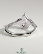 Kynora CJ 2ct pear-shaped diamond solitaire engagement ring with round shoulder stones in a sleek platinum setting.