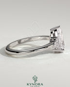 Kynora CJ 2ct Pear Claw Solitaire engagement ring with round shoulder stones and detailed band design.