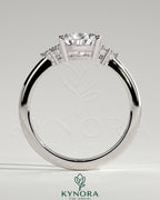 Kynora CJ 2ct pear-shaped diamond solitaire engagement ring with round shoulder stones and sleek band design.