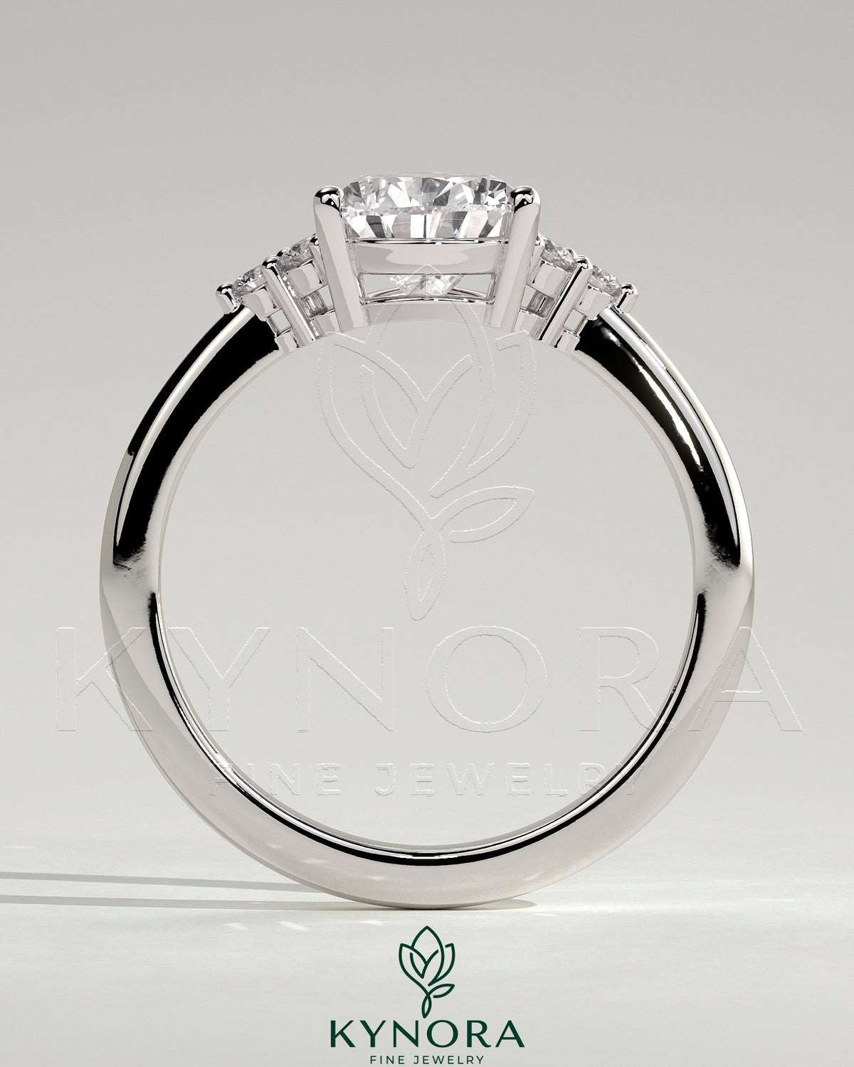 Kynora CJ 2ct pear-shaped diamond solitaire engagement ring with round shoulder stones and sleek band design.