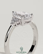 Kynora CJ 2ct pear-shaped diamond solitaire engagement ring with round shoulder accent stones, elegant and sparkling jewelry piece.