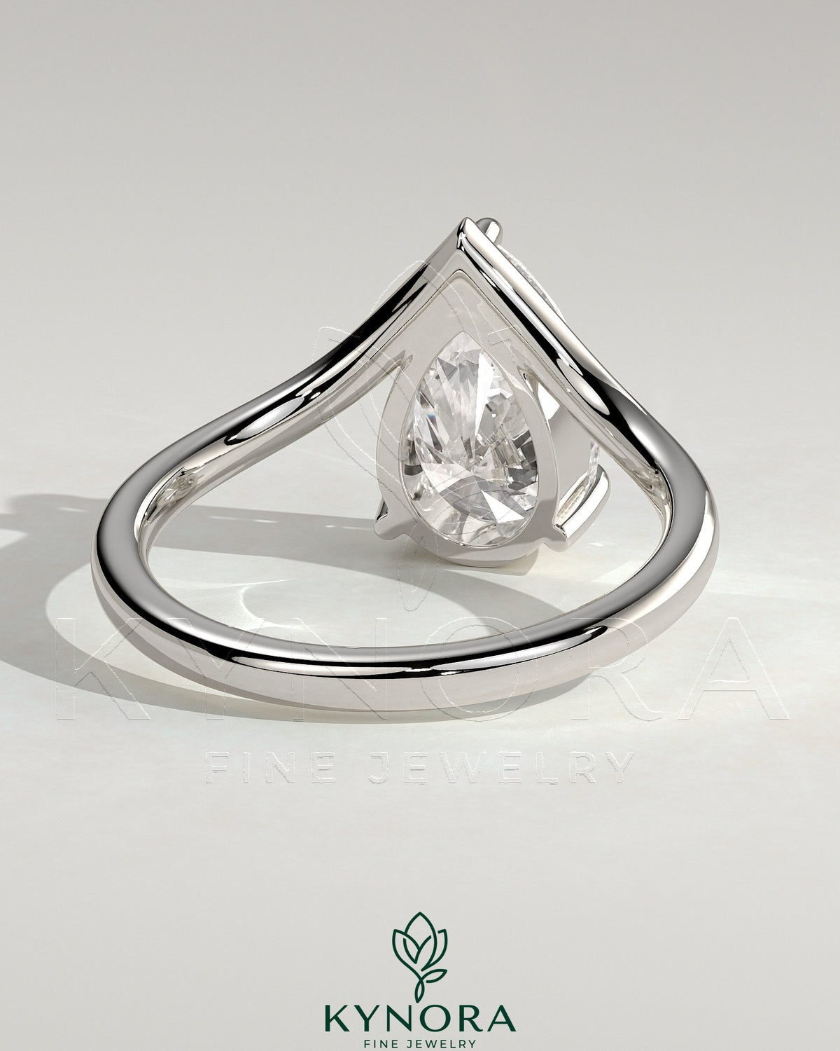 Kynora CJ 2ct pear-shaped diamond solitaire engagement ring with V-shaped band, crafted in elegant jewelry style.