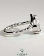 Kynora CJ 2ct pear-shaped diamond solitaire engagement ring with V-shaped band, elegant and sparkling jewelry.