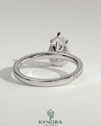 Kynora CJ 2ct pear-shaped diamond solitaire engagement ring with wrap-around hidden halo and pave band, five-prong setting.