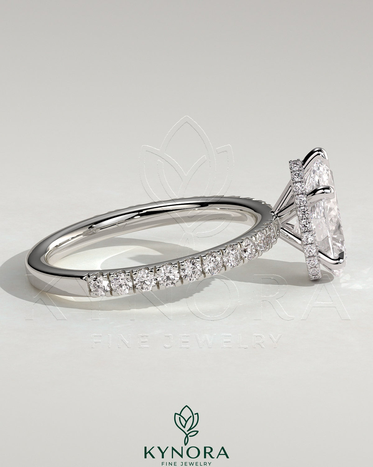 Kynora CJ 2ct pear-shaped diamond solitaire engagement ring with wrap-around hidden halo and pave band.