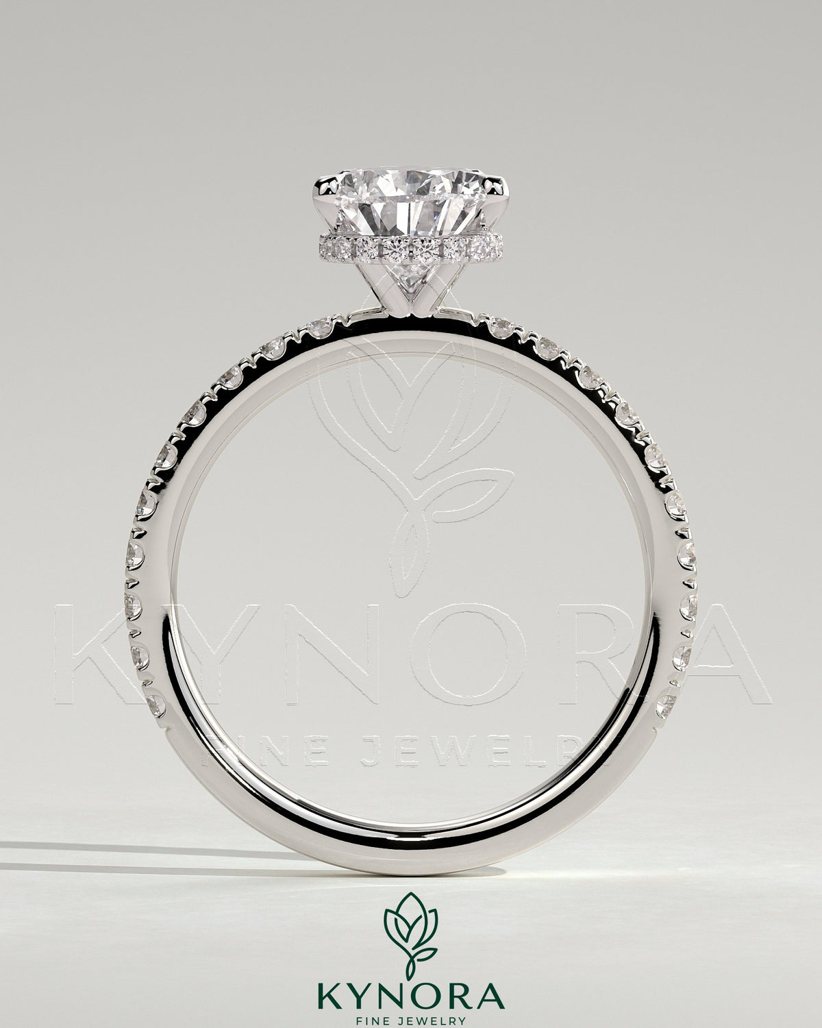 Kynora CJ 2ct pear-shaped diamond solitaire engagement ring with wrap-around hidden halo and pavé band, five-prong setting