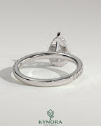 Kynora CJ 2ct pear-shaped diamond solitaire engagement ring with wrap-around hidden halo and pavé band, three-prong setting.