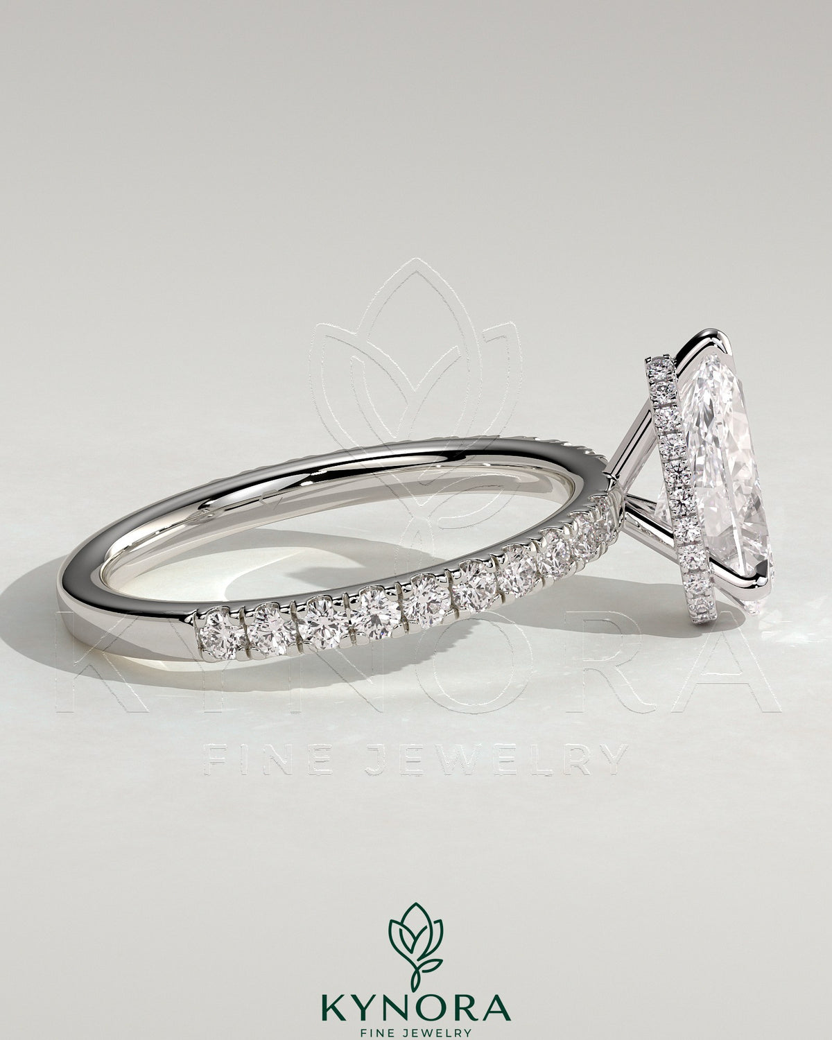 Kynora CJ 2ct pear-shaped diamond solitaire engagement ring with hidden halo and pave band, three-prong setting.