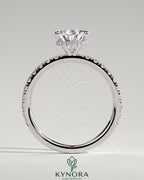 Kynora CJ 2ct pear-shaped diamond solitaire engagement ring with wrap-around hidden halo and pave band, three-prong setting