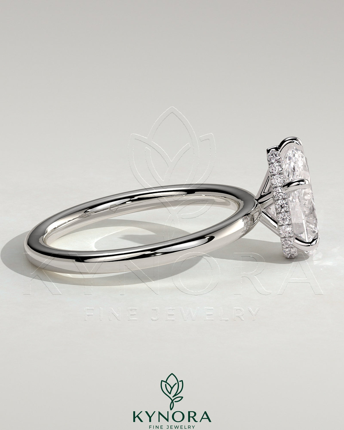 Kynora CJ 2ct pear-shaped diamond solitaire engagement ring with wrap-around hidden halo and sleek band.