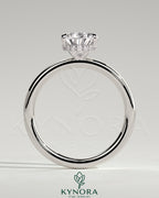 Kynora CJ 2ct pear-shaped diamond solitaire engagement ring with wrap-around hidden halo and sleek band.