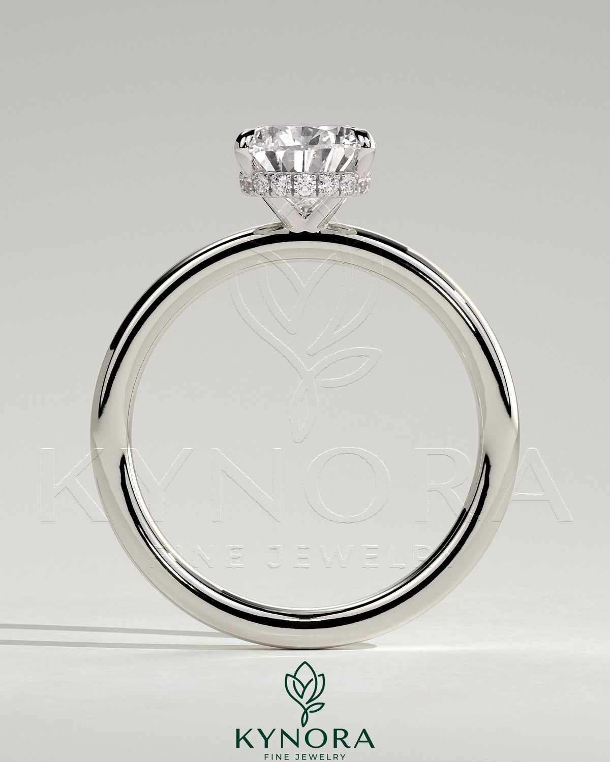 Kynora CJ 2ct pear-shaped diamond solitaire engagement ring with wrap-around hidden halo and sleek band.