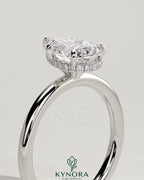 Kynora CJ 2ct pear-shaped diamond solitaire engagement ring with wrap-around hidden halo setting.