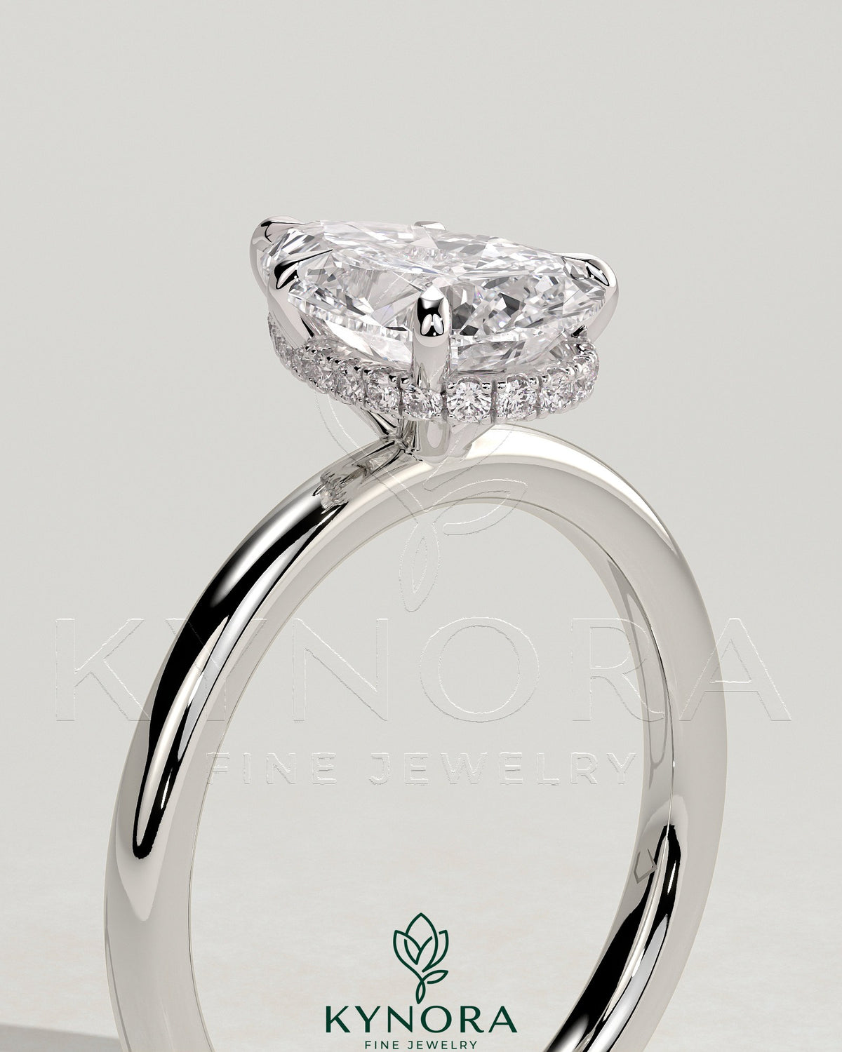 Kynora CJ 2ct pear-shaped diamond solitaire engagement ring with wrap-around hidden halo setting.