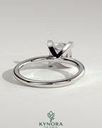 Kynora CJ 2-carat princess cut solitaire engagement ring with a sleek band and sparkling center stone on a white background.