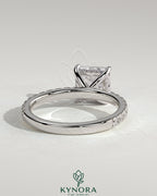 Kynora CJ 2ct princess cut solitaire engagement ring with hidden halo and pave band, showcasing elegant diamond design.