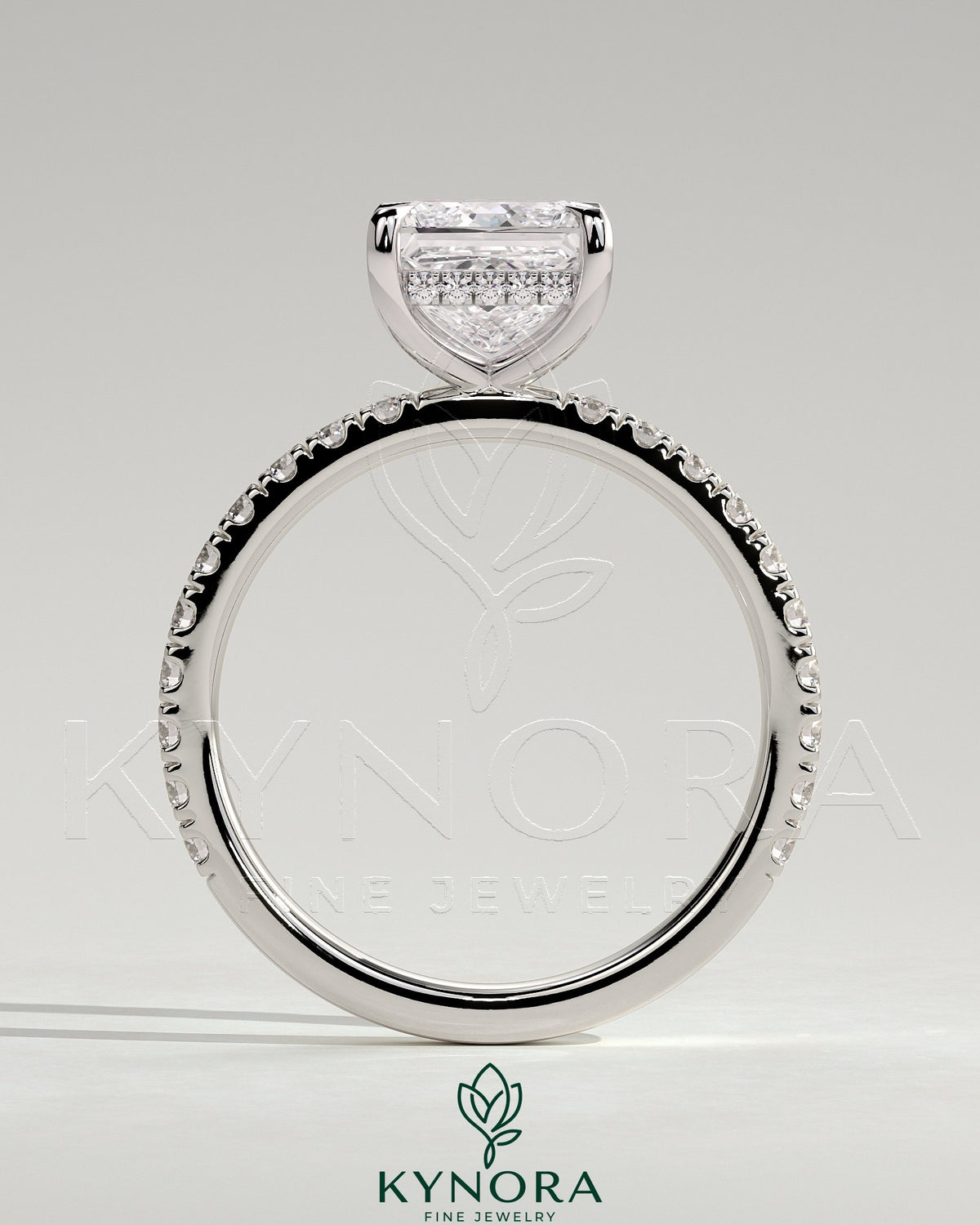 Kynora CJ 2ct princess claw solitaire engagement ring with hidden halo and pavé band, featuring a sparkling central diamond.