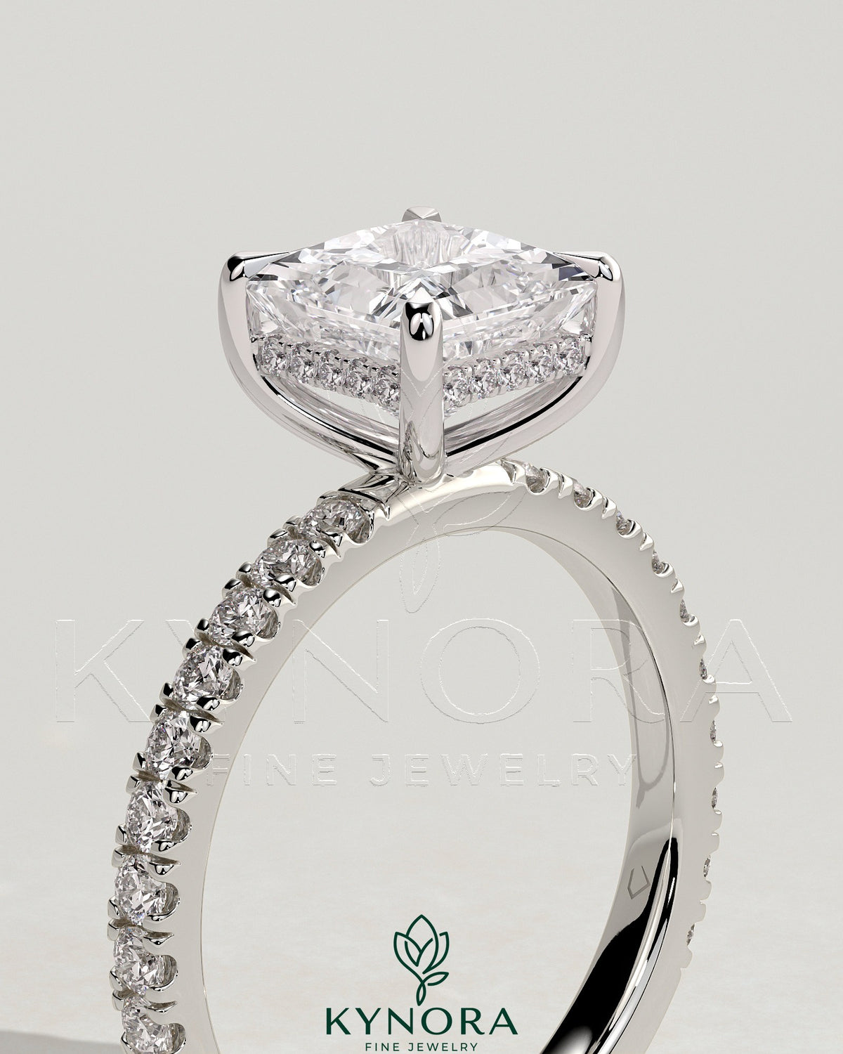 Kynora CJ 2ct princess claw solitaire engagement ring with hidden halo and pave band, showcasing a sparkling diamond setting.