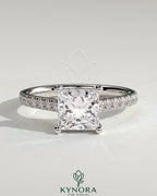 Kynora CJ 2ct princess claw solitaire engagement ring with hidden halo, pave band, and cathedral high setting.