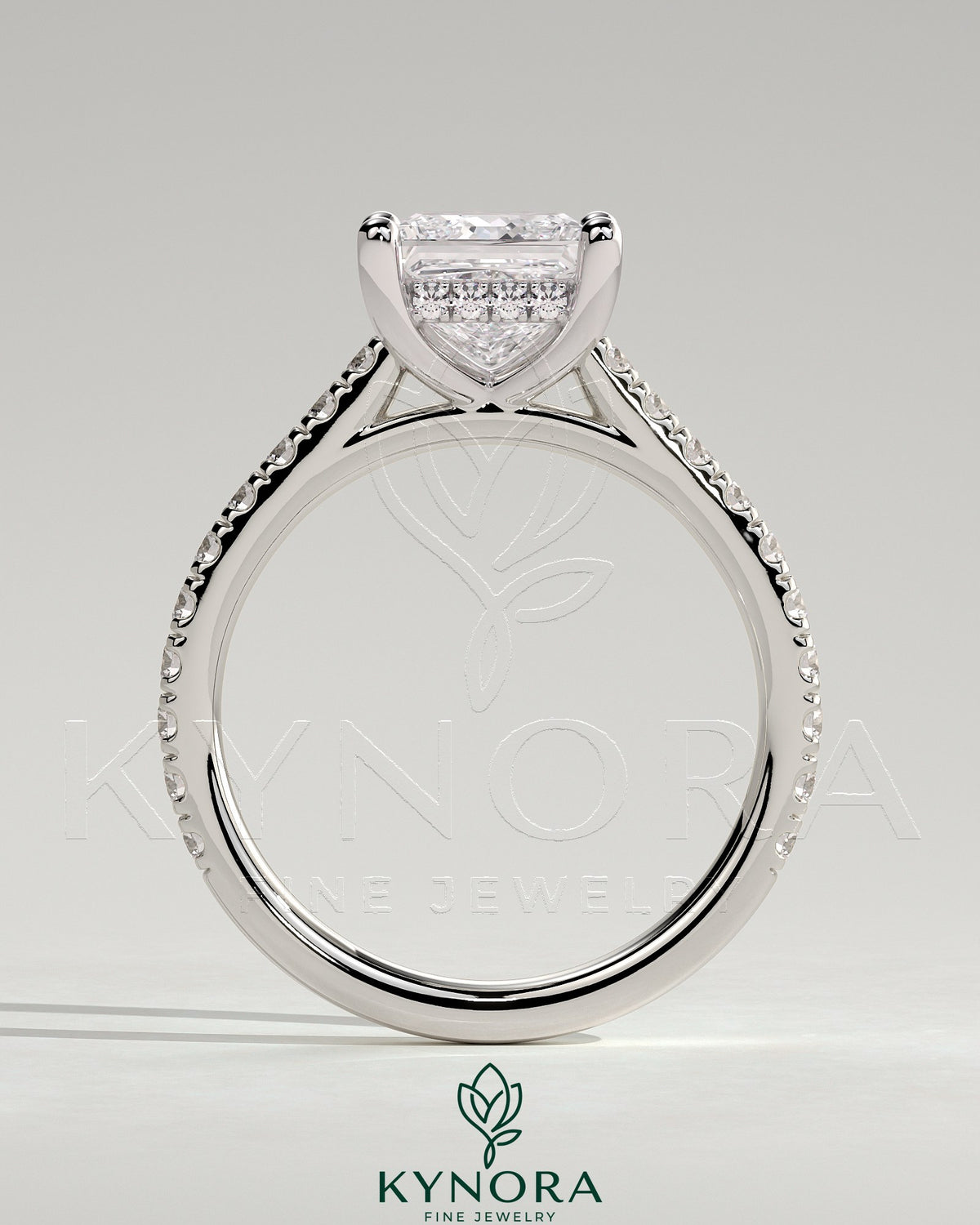 Kynora CJ 2ct princess claw solitaire engagement ring with hidden halo, pave band, and cathedral high setting.