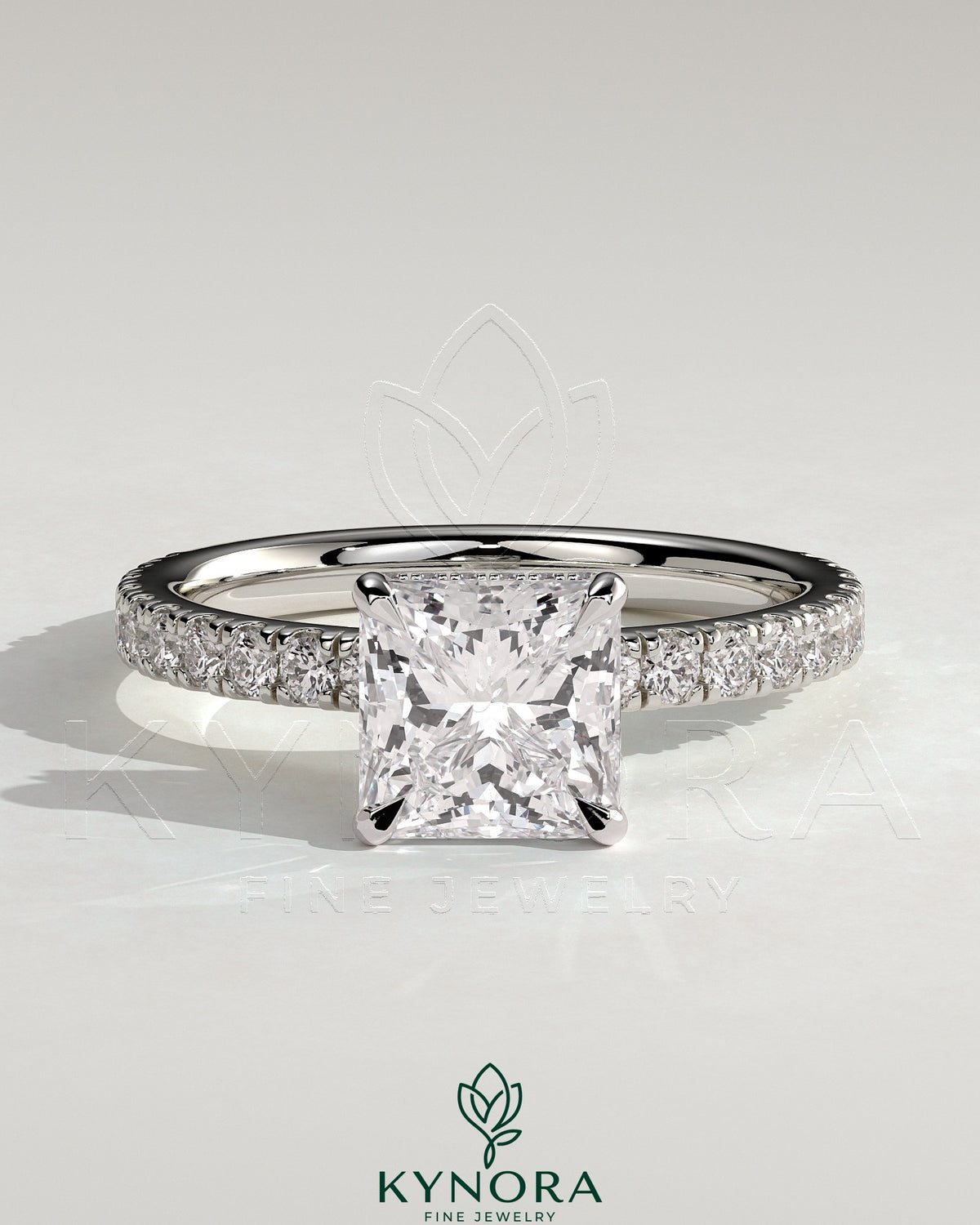 Kynora CJ 2ct princess claw solitaire engagement ring with wrap-around hidden halo and pave band, showcasing sparkling diamond details. Main image