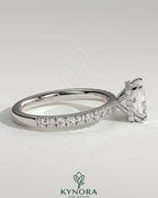 Kynora CJ 2ct princess cut solitaire engagement ring with wrap-around hidden halo and pavé band in a sparkly jewelry display