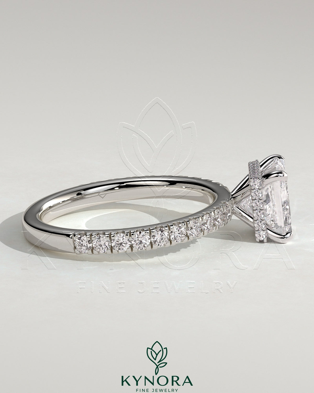 Kynora CJ 2ct princess cut solitaire engagement ring with wrap-around hidden halo and pavé band in a sparkly jewelry display