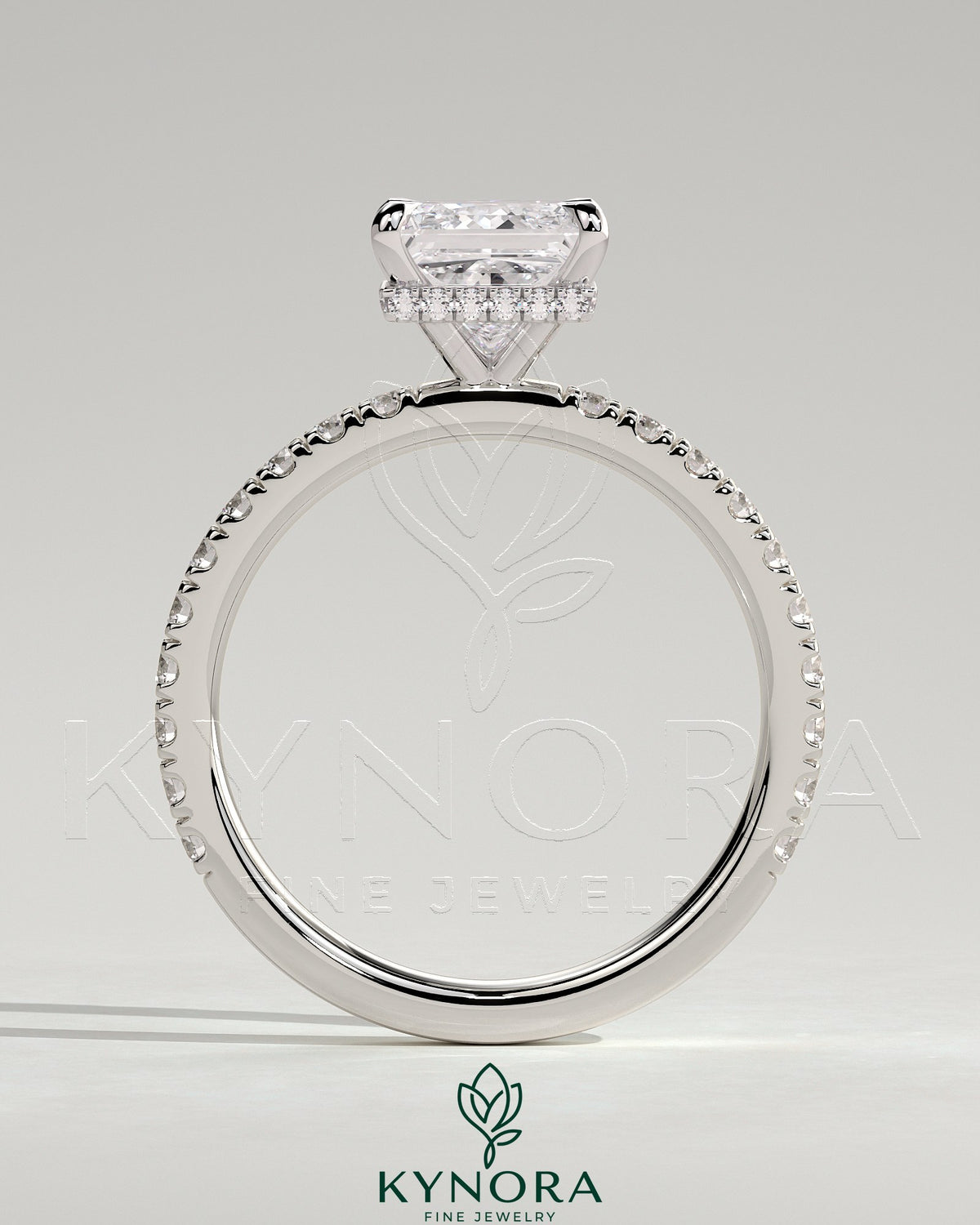 Kynora CJ 2ct princess claw solitaire engagement ring with wrap-around hidden halo and pavé band, showcasing sparkling diamond details.