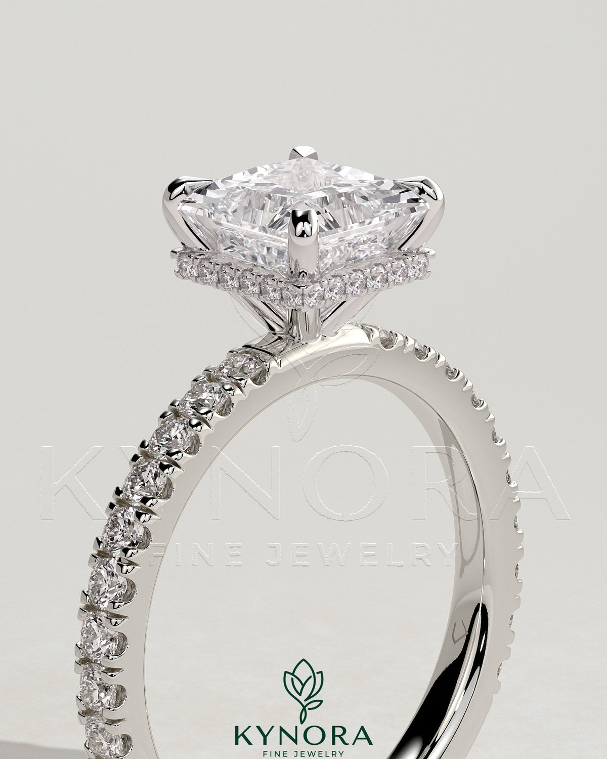 Kynora CJ 2ct princess claw solitaire engagement ring with wrap-around hidden halo and pave band, showcasing elegant jewelry craftsmanship.
