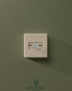 Kynora CJ 2ct radiant cut solitaire engagement ring with a claw setting, showcasing a sparkling central diamond on a sleek band.