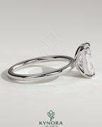 Kynora CJ 2ct radiant cut solitaire engagement ring with claw setting, showcasing a sparkling central diamond on a sleek band.