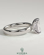 Kynora CJ 2ct radiant cut claw solitaire engagement ring with cigar band and hidden halo, showcasing elegant jewelry craftsmanship.